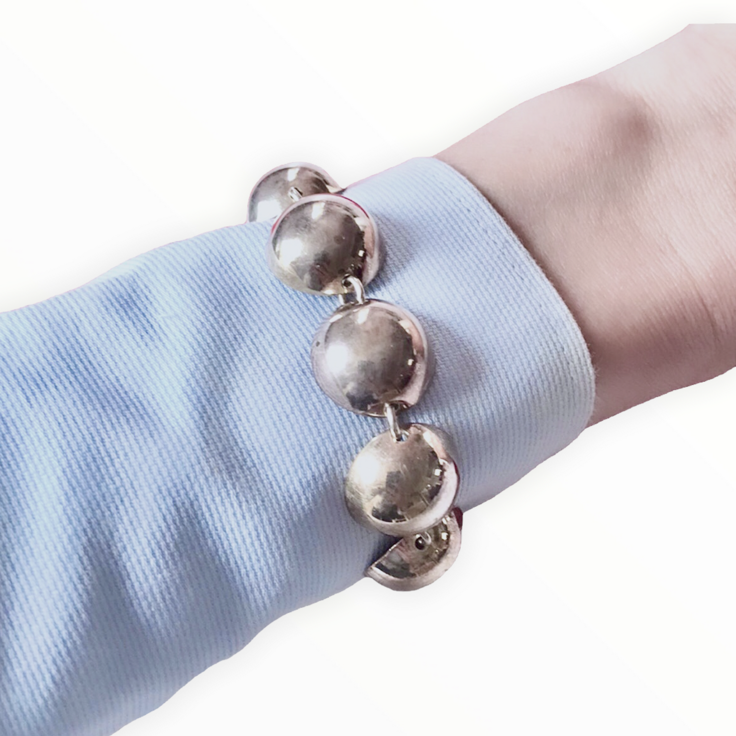 A semi-spherical silver bracelet from conceptual futuristic Cosmic Collection.
